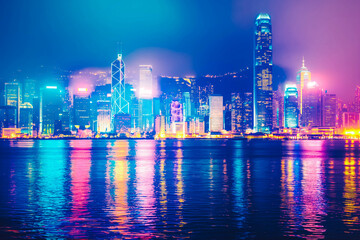 Wall Mural - A stunning city skyline at night, illuminated by the glow of neon lights and skyscrapers, capturing the energy of urban life.