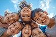 © Chacmool - group of happy kids looking at camera and smiling on blue sky background