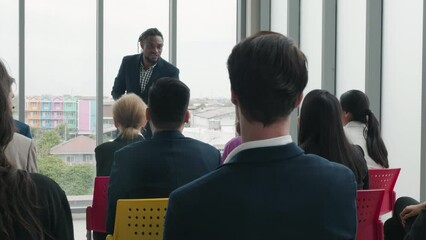 Wall Mural - Business leaders present their reviews in meeting room, with diverse group of colleagues sitting and listening attentively. represents the teamwork and successful collaboration drives productivity.