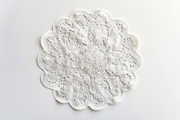 A delicate lace doily, adding a touch of elegance to any setting, isolated on pure white background.