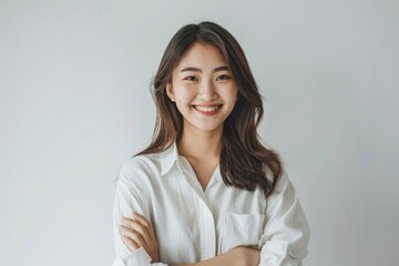 Asian Female Lifestyle: Young CEO in Casual Attire with Pleasing Expression and Arms Crossed, White Background