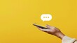 © Borin - Capture the simplicity of mobile messaging with a minimalist composition of a hand holding a smartphone, with a chat bubble icon visible on the screen, against a solid-colored background