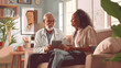© john - Senior mixed race man with female doctor home visiting talking using tablet