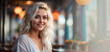 © Елена Атаманюк- Кало - An attractive young blonde is sitting in a cafe,