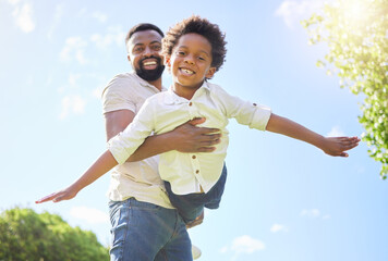 Black man, boy and flying game in portrait outdoor with support, bonding and love for care in garden on vacation. Family, nature and smile on adventure, balance and childhood as airplane together