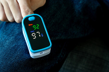 oxygen meter, patients use fingertip oximeter, measuring oxygen levels as basic health check.