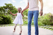 © peopleimages.com - Happy, father and child on trampoline in garden, holding hands and jumping together. Fun, playing and girl kid cheerful for support on a rebounder, bouncing with daddy and family in a backyard