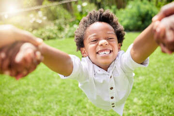 Portrait, boy and spin from parent in outdoor for fun with circle movement, excitement and bonding for energy in garden. Smile, black kid and holding hands in backyard for speed, support or game