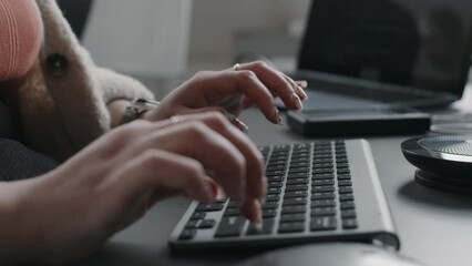 Wall Mural - closeup of unrecognizable female hands of programmer typing on wireless keyboard at office desk