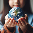© Maryna - A child holds the planet Earth in his palms