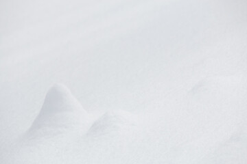 Wall Mural - small mounds of white snow surface in winter landscape background