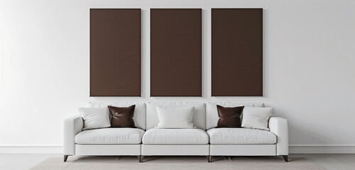 Minimalist interior with three blank chocolate canvases and white sofa, high-definition 3D render.