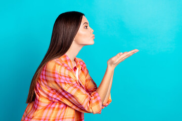 Poster - Profile photo of nice young girl arms send air kiss empty space wear plaid shirt isolated on teal color background