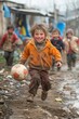 © Tetiana Kasatkina - Active children in the slum courtyard play with a ball, kids play sports