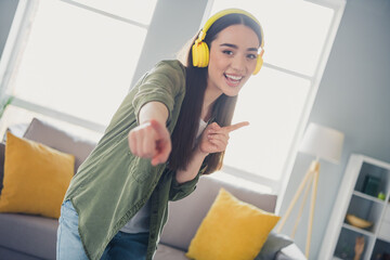 Canvas Print - Portrait of nice young girl dance headphones point fingers you wear green shirt modern interior flat indoors