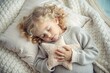 © Юлия Клюева - A little blonde girl with curly long blonde hair is sleeping in her bed, hugging a plush star.