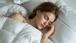 © HillTract - A lovely young woman peacefully sleeps in her white bed