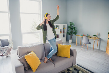 Canvas Print - Full length portrait of nice young girl dance sofa wear green shirt modern interior flat indoors