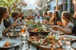 © itchaznong - A group of people are gathered around a long table with food and drinks