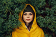 © SHOTPRIME STUDIO - Woman in yellow raincoat hiding behind evergreen trees, outdoor adventure travel concept in nature wilderness forest landscape