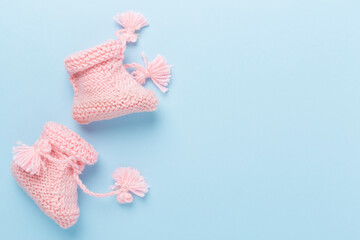 Wall Mural - Pink baby booties on color background, top view