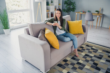 Canvas Print - Full length portrait of nice young girl use smart phone wear green shirt modern interior flat indoors