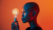 © Atijano - Black woman holding a light bulb with her hand