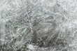 © Martin - Close-up of an ice hockey rink surface, showcasing a detailed network of scratches and lines in a cool grey tone
