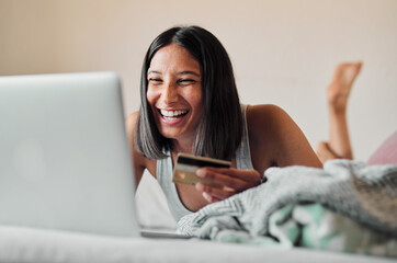 Canvas Print - Girl, laptop and credit card for payment on bed, ecommerce and laughing on banking app or website. Female person, finance transaction and online shopping or fintech, investment planning and sale