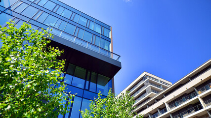 Wall Mural - Sustainable glass office building with trees for reducing carbon dioxide. Eco-friendly building in modern city. Office with green environment. Corporate building reduce CO2.