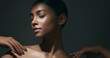 © peopleimages.com - Beauty, sensual and face of woman in studio for cosmetic, natural and dermatology treatment. Skincare, clean and young Indian female model with healthy glow skin moving isolated by gray background.