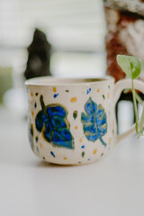 Wall Mural - Beautiful hand-made ceramic mug displayed on the table