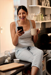 Poster - Morning, laugh and woman with cellphone in home for social media, chat and online comedy with contact. House, girl and smartphone for networking, browsing and scrolling in kitchen with coffee cup