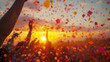 © nopommajun - Vibrant image of hands up in celebration during sunset, with flying confetti creating a festive mood