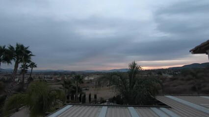 Canvas Print - Time lapse footage showing morning till evening of sky over rural village with trees and houses