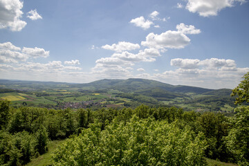 Mountain landscape in Germany near Bad-Sooden-Allendorf. View of Messner Kress in the background on a beautiful sunny day with blue sky and clouds in springtime