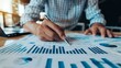 © kamonrat - Charts and graphs accompany financial documents, depicting an advisor conducting thorough investment research.