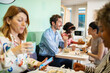 © Marko Geber - Multicultural colleagues having a lunch break in a bright office space