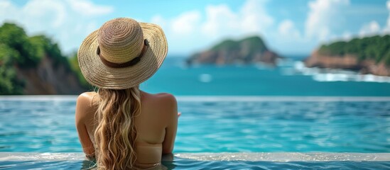 Wall Mural - Portrait of woman enjoying vacation at luxury beachfront hotel resort with swimming pool with tropical landscape