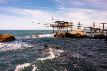 Wall Mural - Traditional wooden fishing house with a net near sea coast