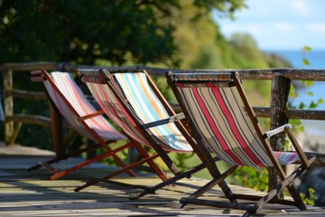 Wall Mural - Three colorful striped deck chairs overlooking a tranquil lake on a sunny day