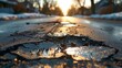 © eric.rodriguez - A wide-view image of a city street in very poor condition, riddled with potholes and damaged asphalt.