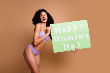 Wall Mural - No filter portrait of stunning model girl happy women day placard look empty space isolated on beige color background