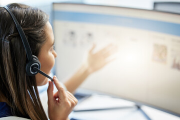 Woman, computer and headset with screen in call center office for telemarketing, consulting and help. Customer service, conversation or helpful crm or tech support agent for online contact in company