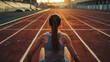© john - Female athlete takes position on running track