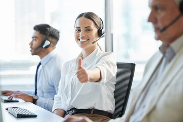 Leinwandbilder - Woman, portrait and happy with thumbs up in call center office with telemarketing for consulting with smile. Customer service, team and helpful crm or tech support agents in online retail company.