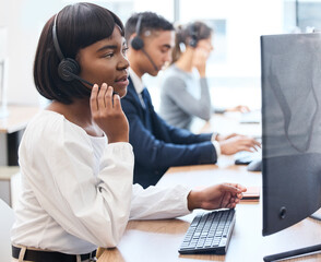 Wall Mural - Call center, desk and black woman with headset, talking and customer service in office and hand. CRM, telemarketing and person with tech support, speaking and agent in agency and work with computer