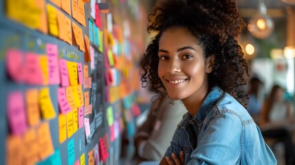 Young Woman Smiling Amid Colorful Sticky Notes in Creative Workspace