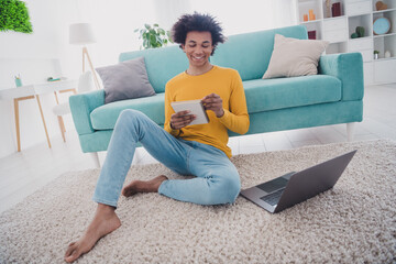 Canvas Print - Full length portrait of nice young man sit floor write notepad laptop wear pullover white interior flat indoors