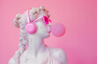 © ALL YOU NEED studio - goddess in pink sunglasses and headphones, blowing bubblegum. Greek statue,modern art, pop culture fusion, contemporary decor, trendy advertisement, youth fashion campaigns, quirky interior design